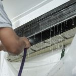 Is air conditioner water safe for pets? That's why a technician is fixing the air conditioner to avoid water dripping.