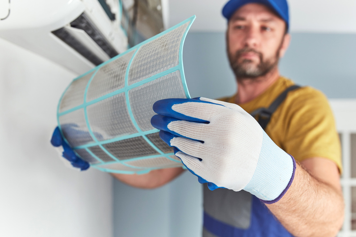 An HVAC expert checks and emphasizes the importance of how often to change the furnace filter in your air conditioner.