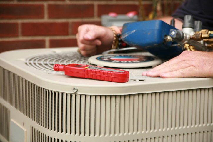 An AC expert demonstrates how to fix overheated air conditioner.