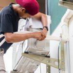 A male technician cleans the ductwork regularly to reduce allergens and dust, extending the lifespan of the HVAC system.