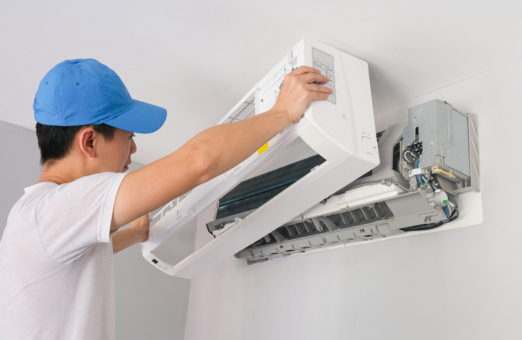 An HVAC expert cleans ducts and air filters to reduce noise in the system.