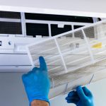 An HVAC specialist checks the unit to determine why the air conditioner is leaking and provides a solution to fix it.