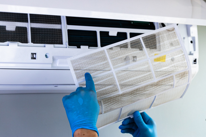 An HVAC specialist checks the unit to determine why the air conditioner is leaking and provides a solution to fix it.