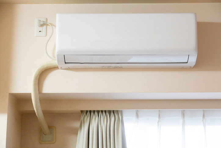 Wall-mounted HVAC unit in a home – understanding HVAC warranty coverage for essential systems.