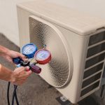 An HVAC professional performing a seasonal tune-up to show how HVAC systems control humidity effectively.