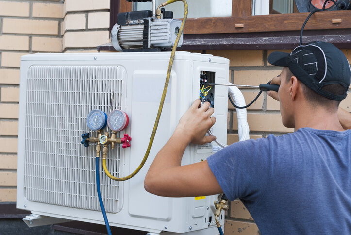 Technician inspecting and upgrading an HVAC system as part of a professional retrofitting service.